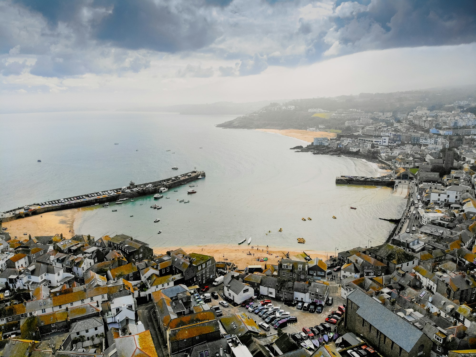 Aerial view of St Ives harbour, slate rooftops and a grey Atlantic sky